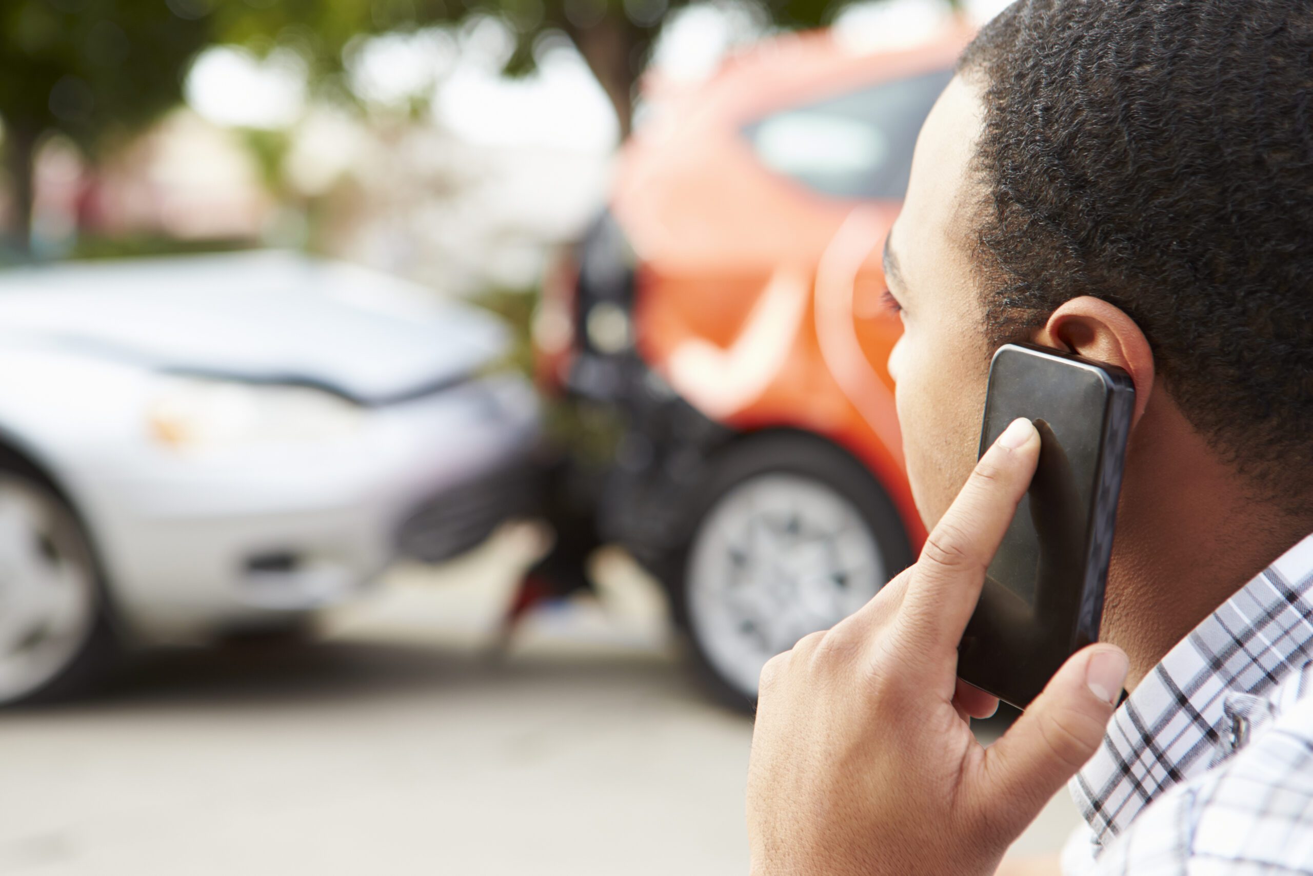 Man on phone after car wreck