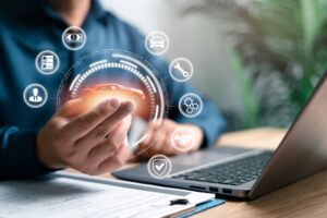 person at laptop holds virtual car to assess vehicle property damage