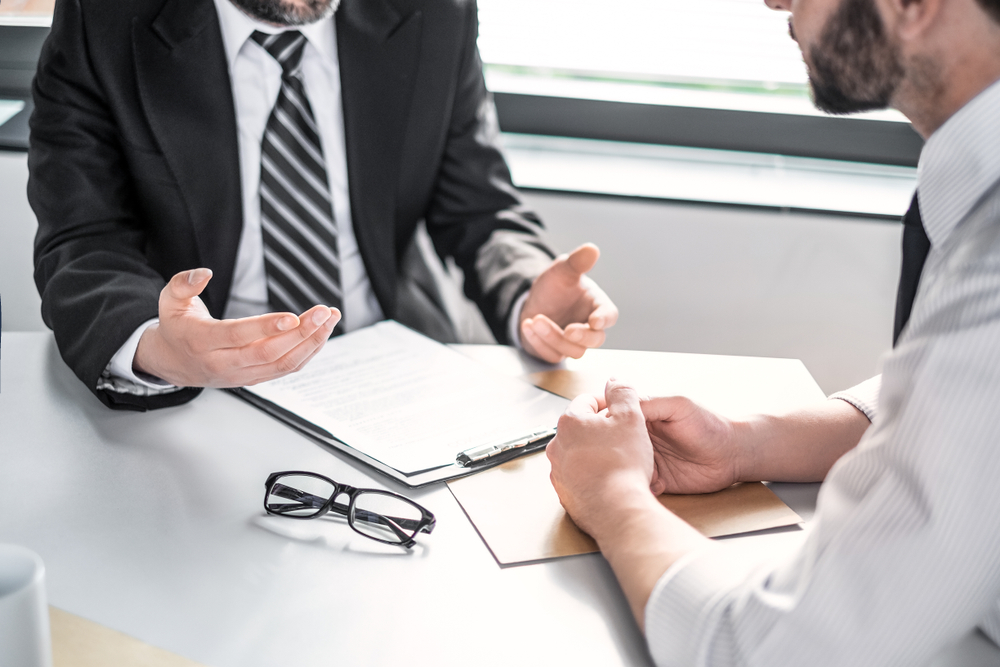 two people negotiating at table